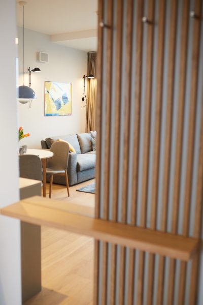 Widok na salon przez drewnianą przesłonę